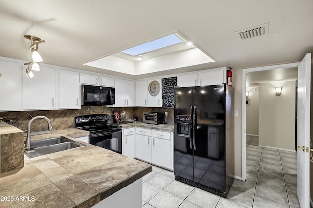 kitchen with white cabinetry, sink, tasteful backsplash, and black appliances