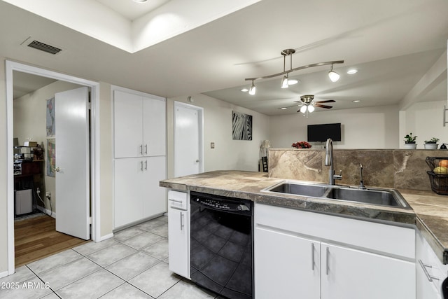 kitchen with dishwasher, sink, light tile patterned flooring, and white cabinets