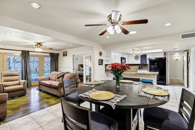 dining room with french doors, ceiling fan, and light tile patterned flooring