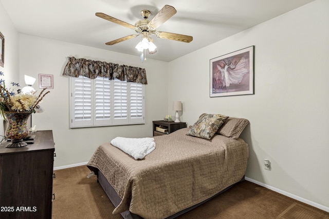 bedroom with ceiling fan and dark carpet