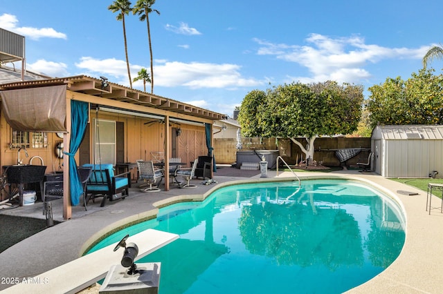 view of pool featuring a storage shed and a patio