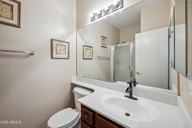 3905 S Bridal Vail Dr, Gilbert, AZ 85297 - bathroom featuring vanity, a shower with shower door, and toilet