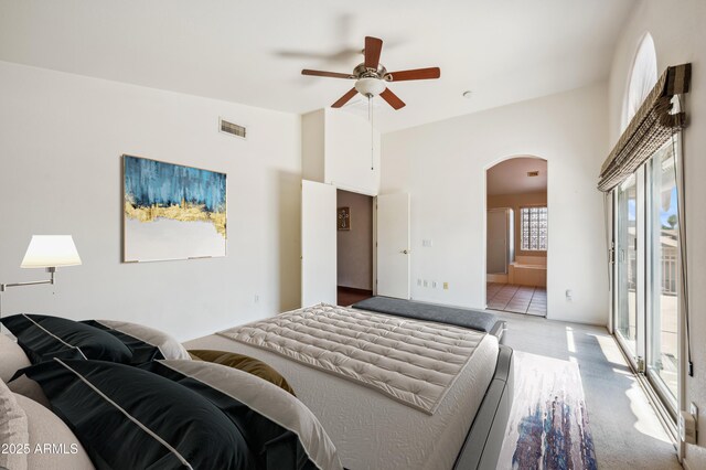 3905 S Bridal Vail Dr, Gilbert, AZ 85297 - bedroom featuring arched walkways, access to exterior, a high ceiling, light carpet, and ensuite bathroom