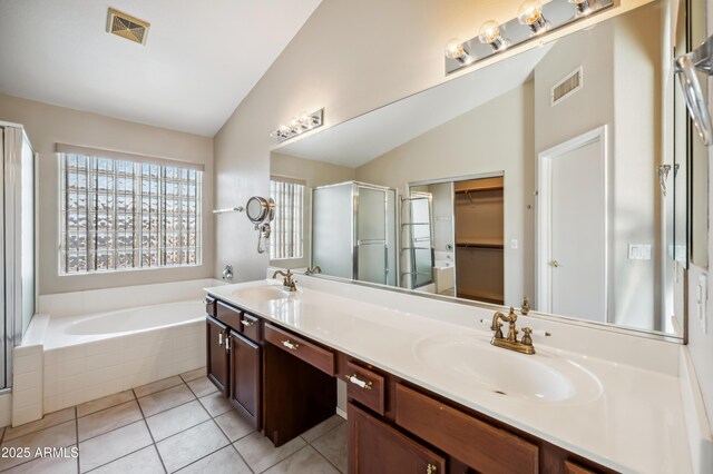 3905 S Bridal Vail Dr, Gilbert, AZ 85297 - full bathroom featuring vaulted ceiling, double vanity, a garden tub, a walk in closet, and a shower stall