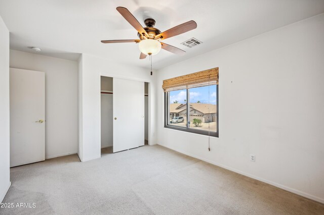 3905 S Bridal Vail Dr, Gilbert, AZ 85297 - unfurnished bedroom featuring light colored carpet, a closet, baseboards, and a ceiling fan