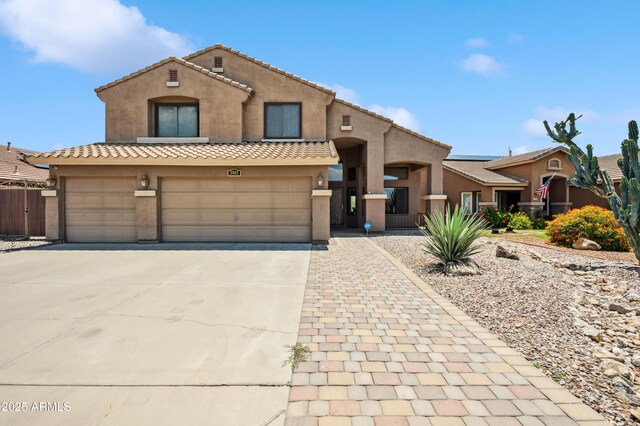 3905 S Bridal Vail Dr, Gilbert, AZ 85297 - view of front of house with stucco siding, concrete driveway, a tile roof, and an attached garage