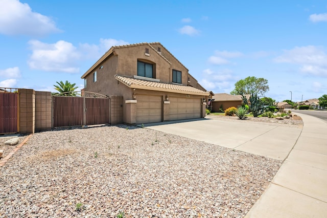 3905 S Bridal Vail Dr, Gilbert, AZ 85297 - view of front of house featuring stucco siding, a gate, driveway, a tiled roof, and a garage