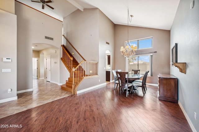 3905 S Bridal Vail Dr, Gilbert, AZ 85297 - dining space with arched walkways, stairway, a chandelier, a ceiling fan, and wood finished floors