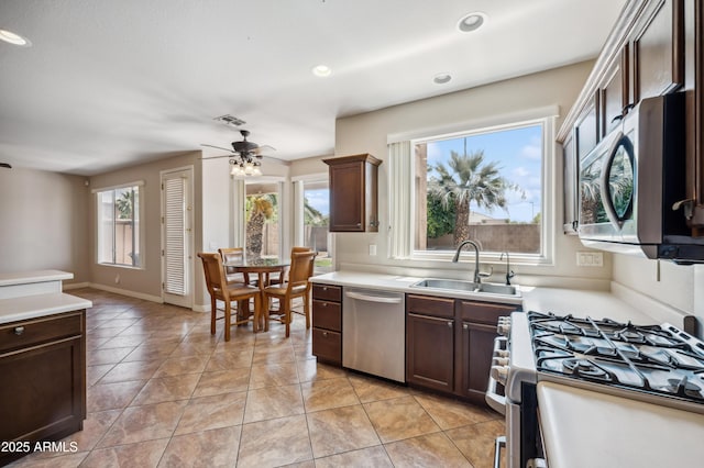 3905 S Bridal Vail Dr, Gilbert, AZ 85297 - kitchen with appliances with stainless steel finishes, a sink, ceiling fan, light countertops, and recessed lighting