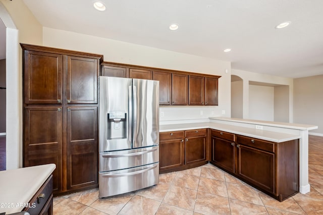 3905 S Bridal Vail Dr, Gilbert, AZ 85297 - kitchen featuring stainless steel fridge, a peninsula, light countertops, recessed lighting, and arched walkways