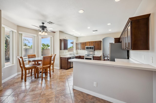 3905 S Bridal Vail Dr, Gilbert, AZ 85297 - kitchen featuring stainless steel appliances, plenty of natural light, light countertops, a peninsula, and recessed lighting