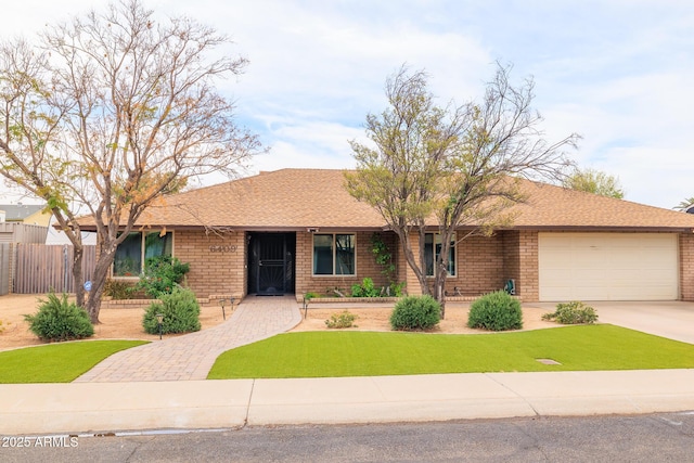 ranch-style house featuring a garage, concrete driveway, roof with shingles, fence, and brick siding