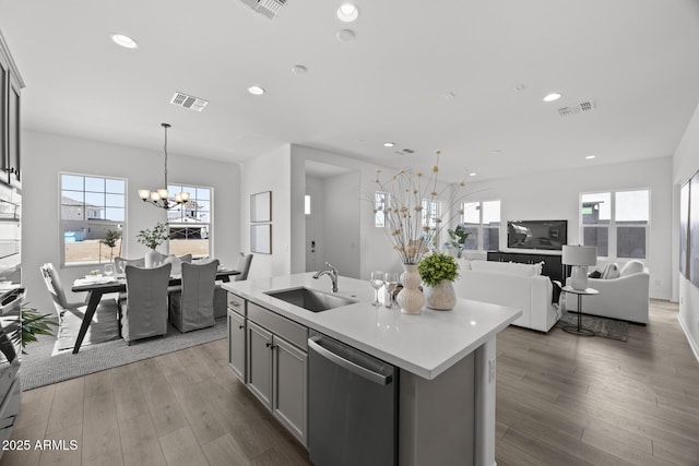 kitchen with a sink, visible vents, a notable chandelier, and dishwasher