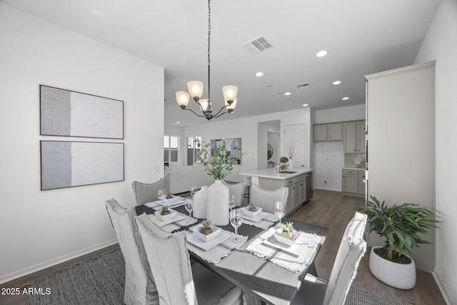 dining area with a notable chandelier, recessed lighting, wood finished floors, and visible vents