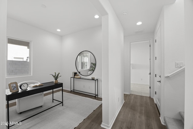 corridor featuring recessed lighting, wood finished floors, and baseboards