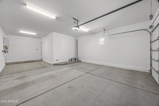 garage with baseboards and a garage door opener