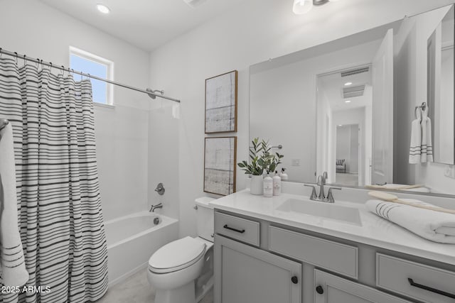 bathroom featuring vanity, shower / tub combo, toilet, and visible vents