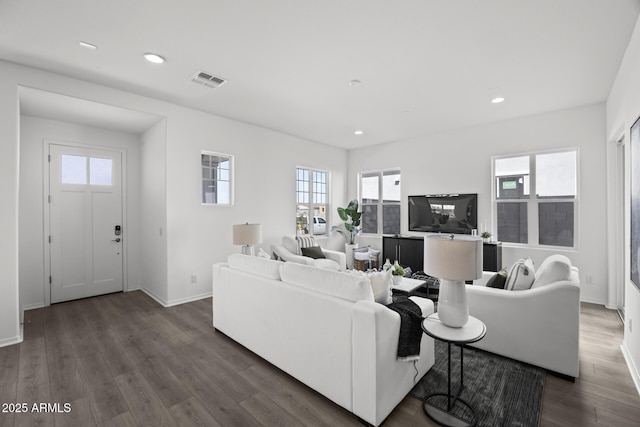 living area featuring dark wood finished floors, visible vents, plenty of natural light, and recessed lighting