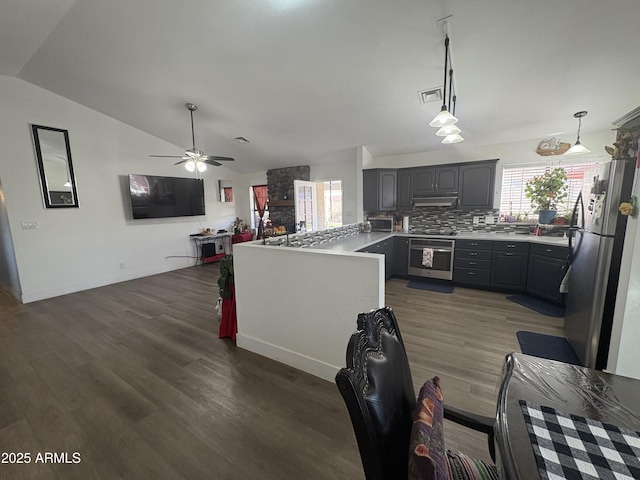 kitchen with gray cabinetry, stainless steel appliances, backsplash, decorative light fixtures, and lofted ceiling