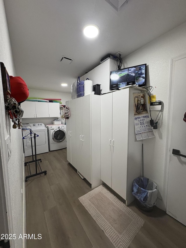 washroom featuring dark hardwood / wood-style floors and washing machine and clothes dryer