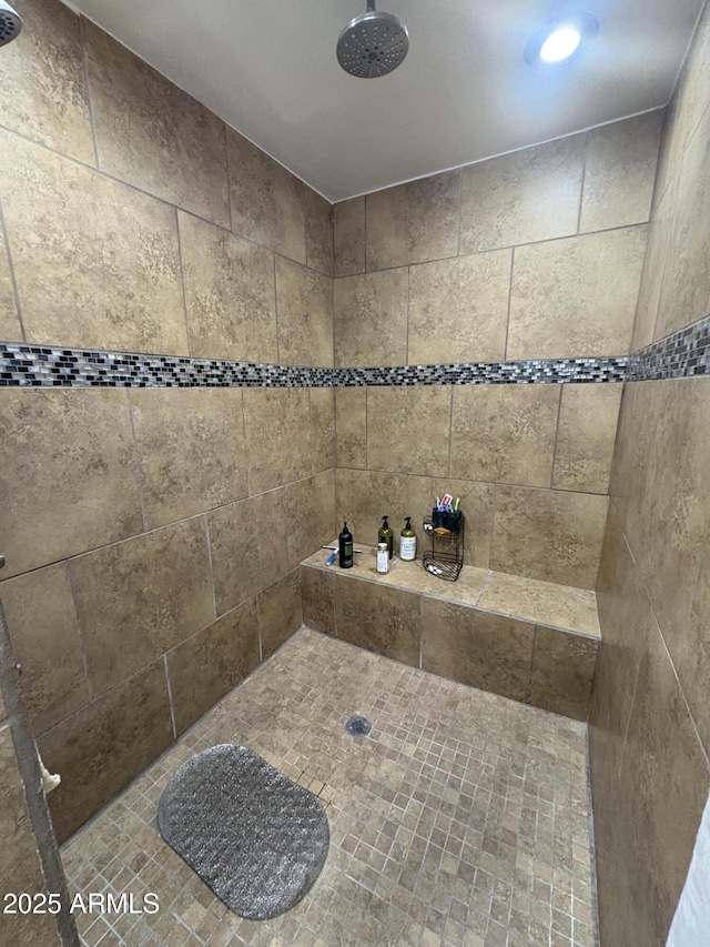 bathroom with tiled shower