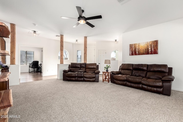 living area with a ceiling fan, carpet flooring, and visible vents