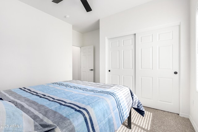 bedroom featuring carpet floors, ceiling fan, baseboards, and a closet