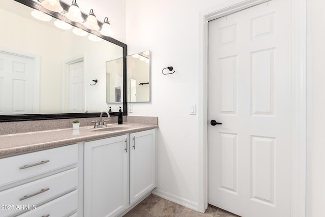 bathroom featuring vanity and baseboards