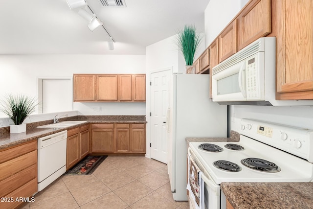 kitchen featuring white appliances, light tile patterned floors, visible vents, and a sink