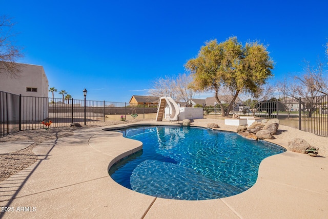 view of pool featuring a fenced in pool, a patio area, a water slide, and a fenced backyard