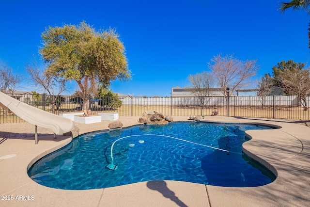 view of pool with a fenced in pool, a water slide, and a fenced backyard