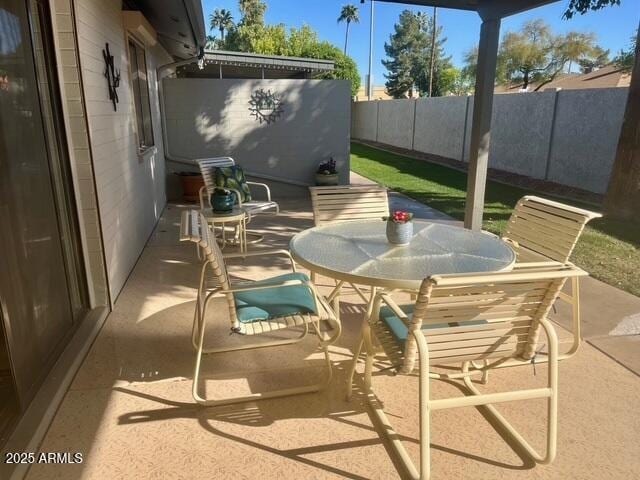 view of patio featuring outdoor dining area and a fenced backyard