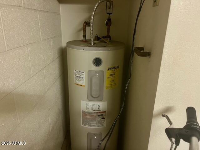 utility room with electric water heater