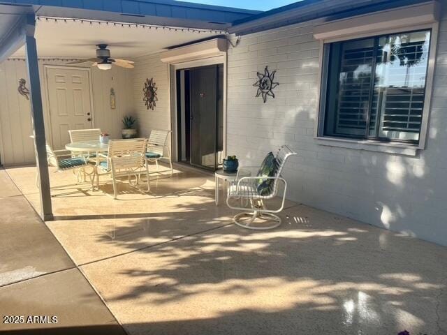 view of patio with outdoor dining area and ceiling fan