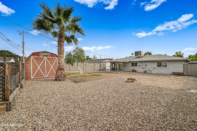 view of yard featuring a storage shed, central air condition unit, and a patio