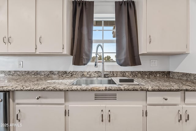 kitchen with white cabinetry and sink