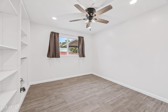 empty room with wood-type flooring and ceiling fan