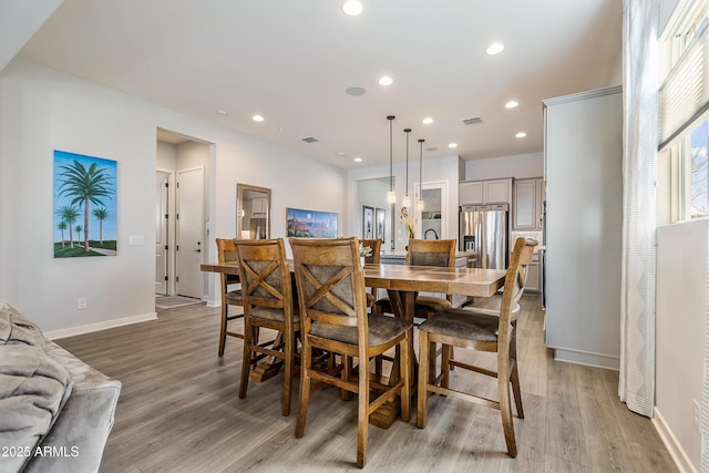 dining room with light wood-type flooring, visible vents, and recessed lighting