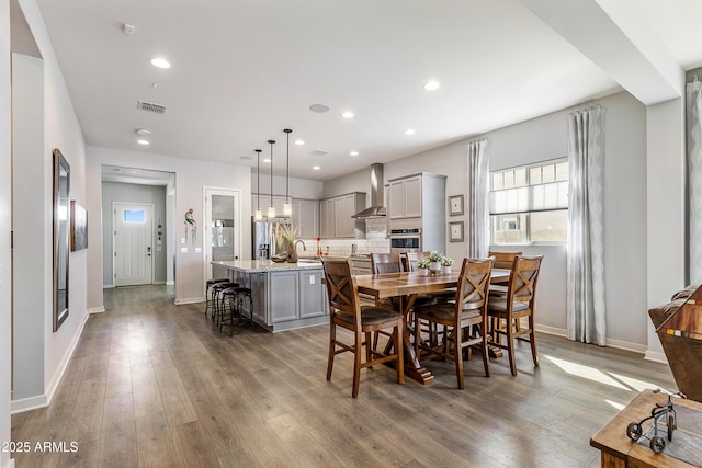 dining room featuring recessed lighting, visible vents, baseboards, and wood finished floors