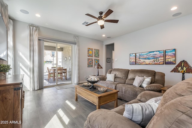 living area with a ceiling fan, recessed lighting, and wood finished floors