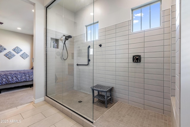 bathroom with a walk in shower, connected bathroom, and tile patterned floors