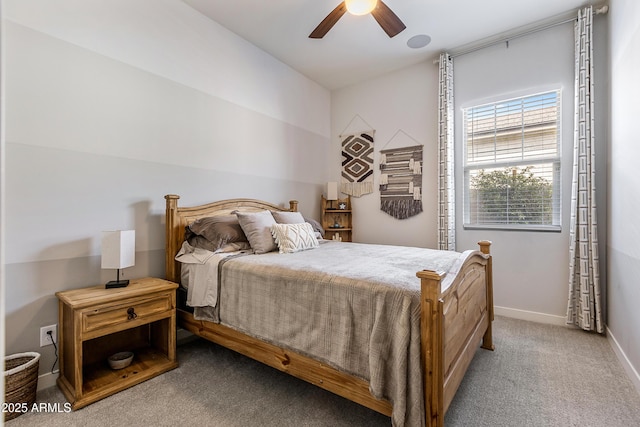 carpeted bedroom with ceiling fan and baseboards