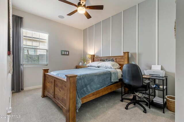 bedroom with baseboards, ceiling fan, and light colored carpet