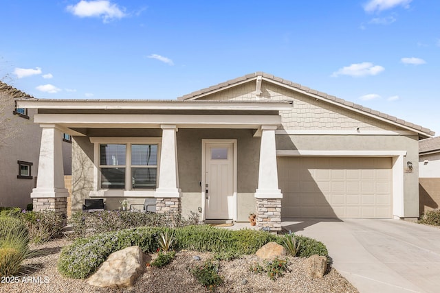 view of front of house with an attached garage, driveway, stone siding, and stucco siding