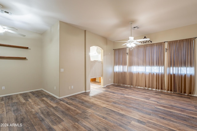 spare room with dark hardwood / wood-style floors and ceiling fan