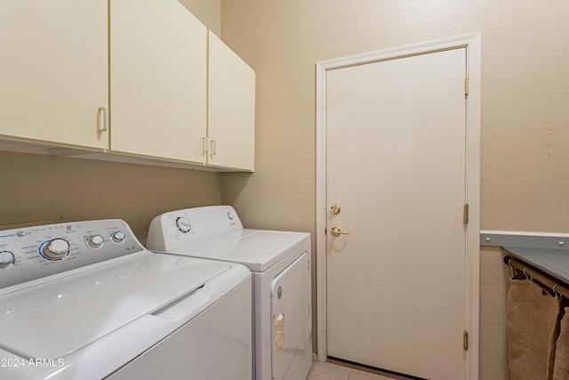 laundry area with cabinets and separate washer and dryer