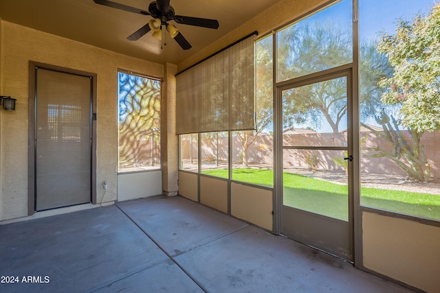 unfurnished sunroom with a wealth of natural light and ceiling fan