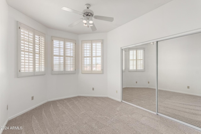 unfurnished bedroom featuring carpet and ceiling fan