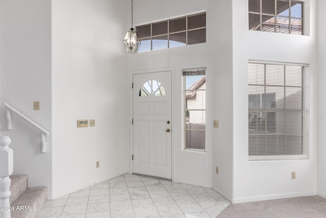 foyer with a healthy amount of sunlight and a high ceiling