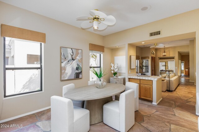 dining room featuring ceiling fan